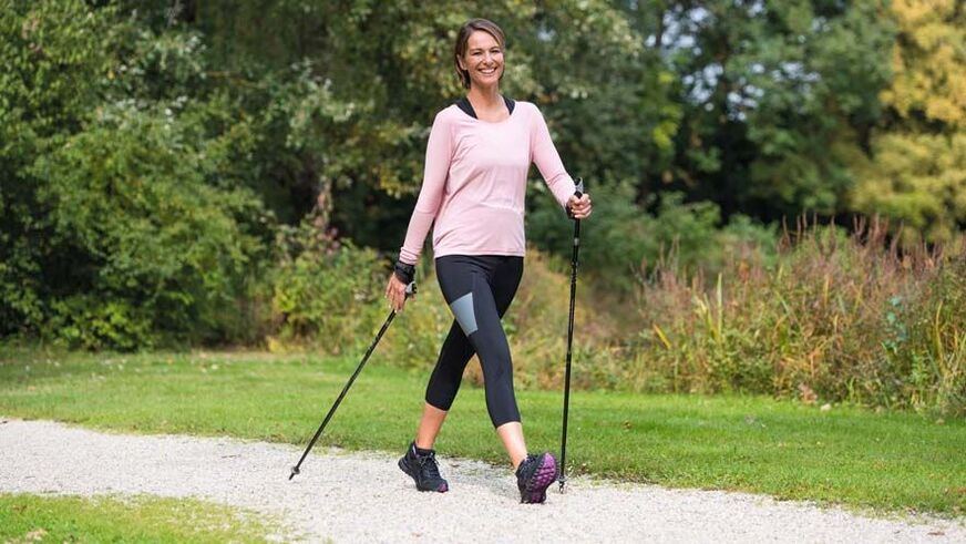 a woman is engaged in walking to prevent back pain